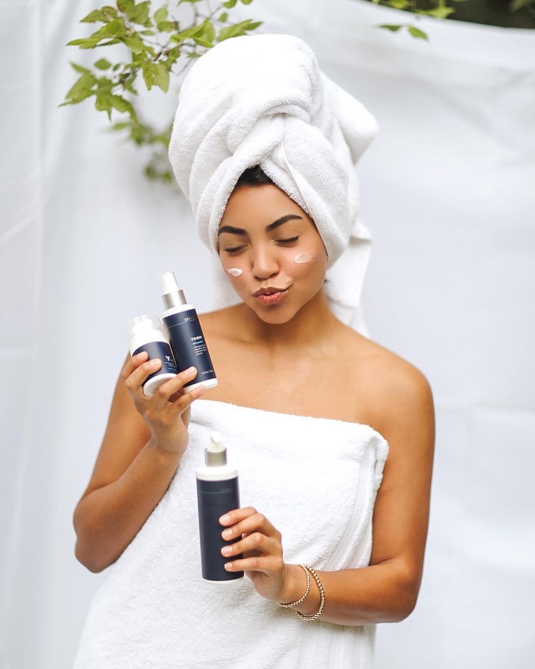 Woman in spa-like bathroom with her Civant product morning routine